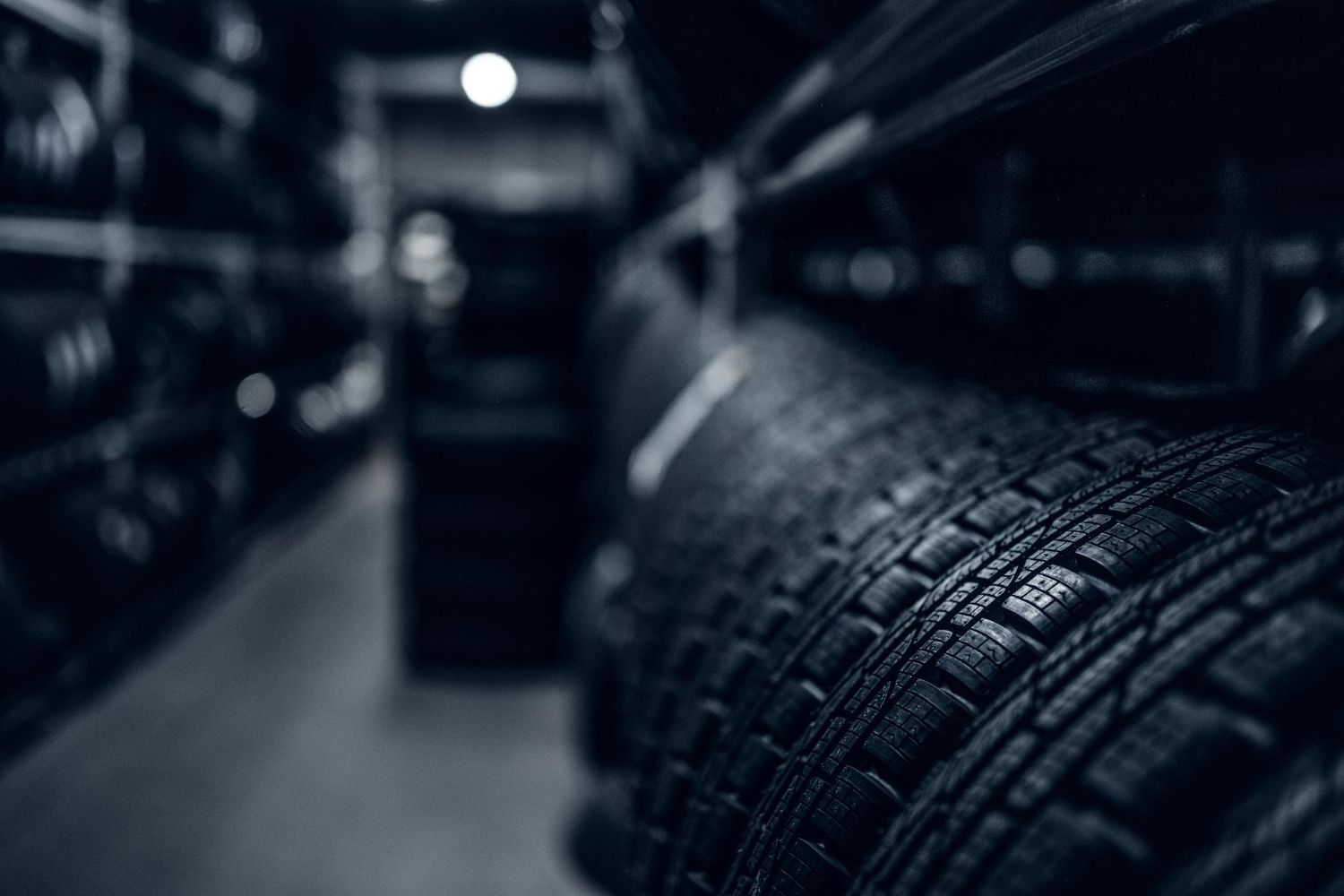 Rows of new car tyres on warehouse shelves